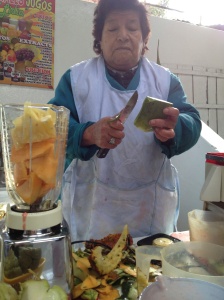 Cusco Peru - juice lady slicing aloe vera into my smoothie